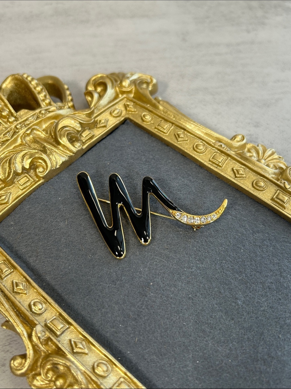 Vintage Trifari Black Enamel and Gold Crescent Brooch with Crystal Accent